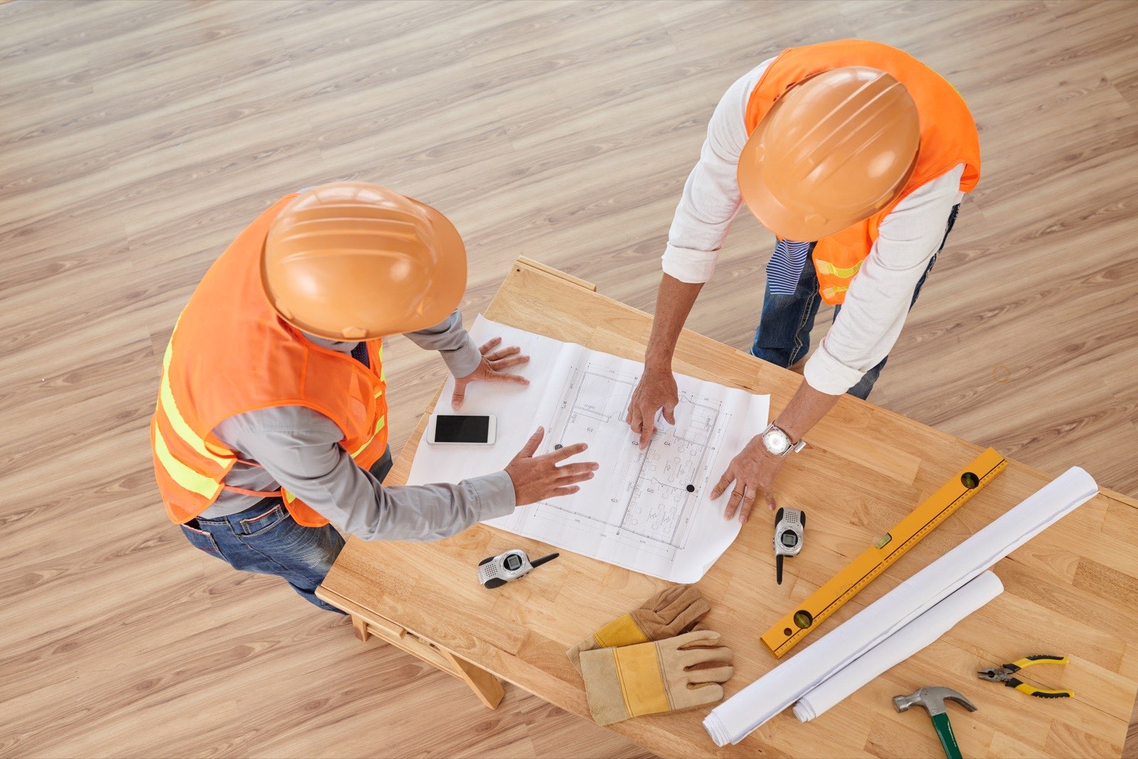 Construction flooring crews in Tucson reviewing plans