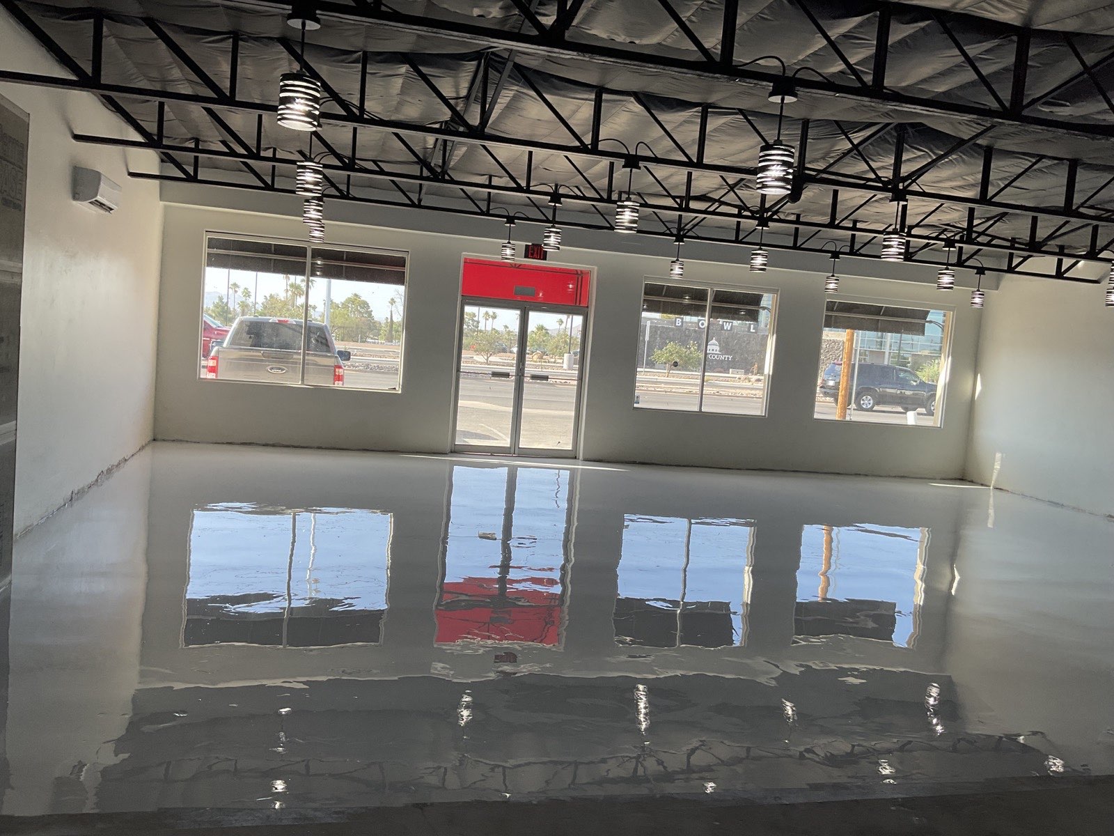 High-gloss commercial epoxy floor with reflective finish in Tucson