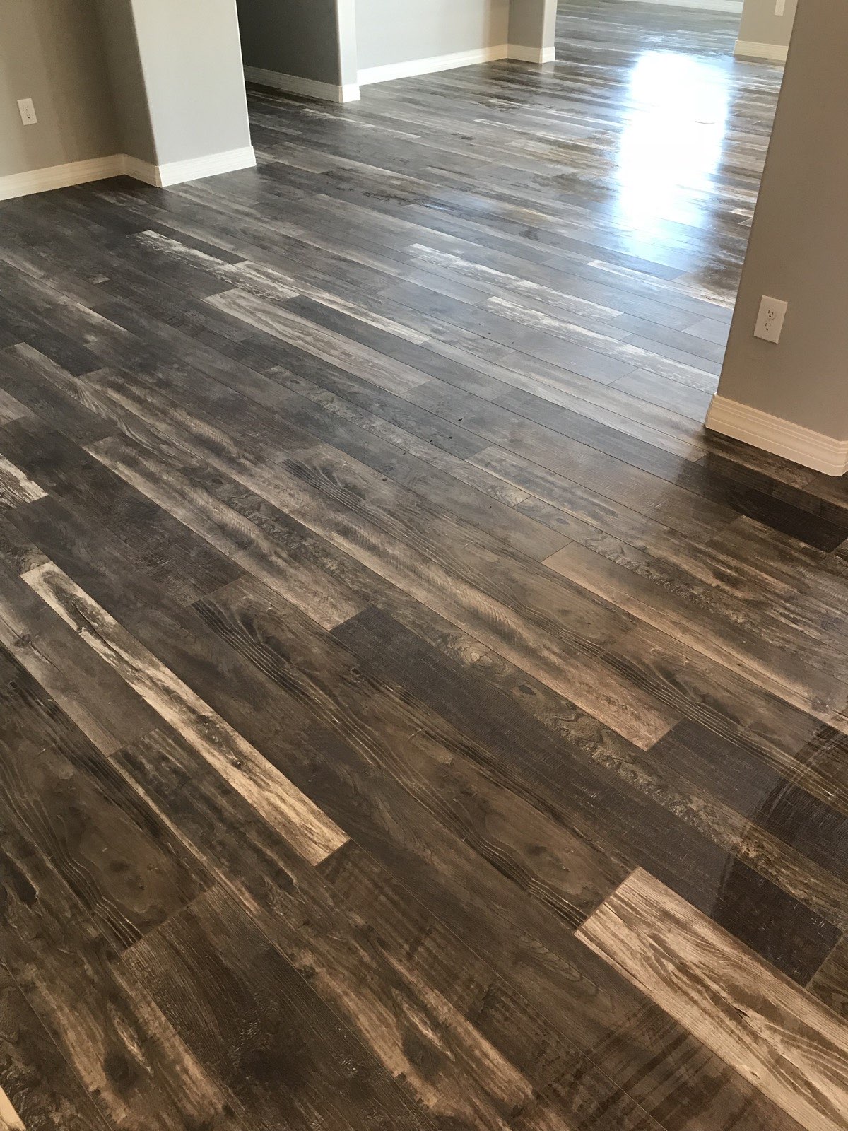 Rustic wood-look laminate flooring installation in a Tucson home