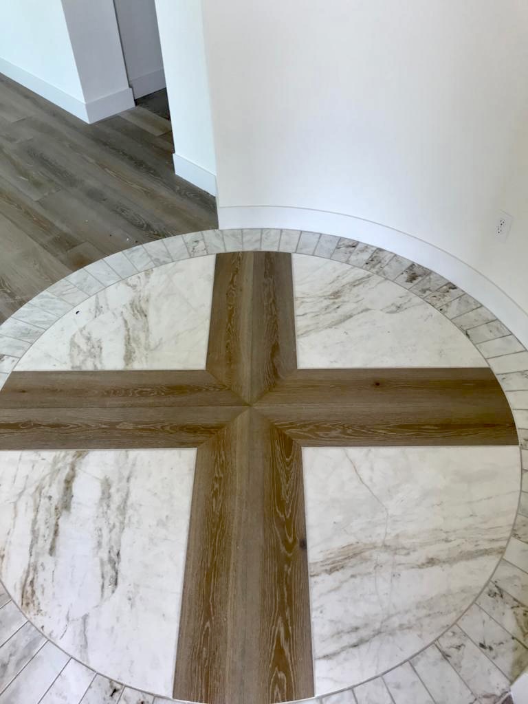 Custom tile medallion with hex mosaic border in residential hallway