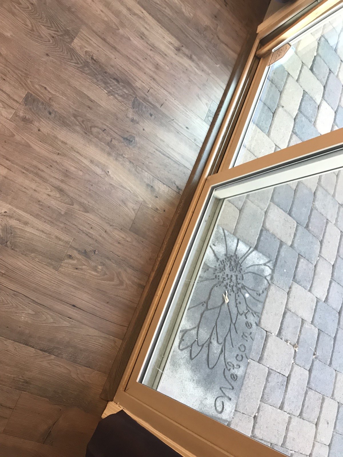 Wood-look laminate planks with varied rustic grain in finished room